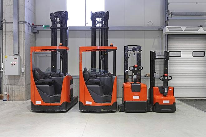 warehouse forklifts in a uniform line